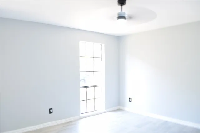 a bathroom with a window and a shower
