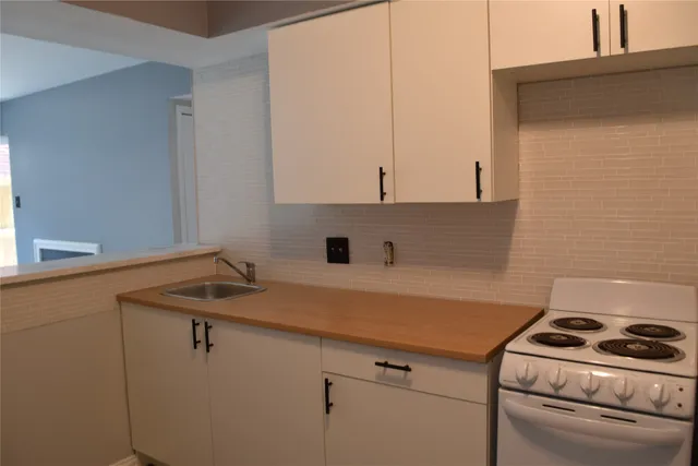a kitchen with a sink stove and cabinets