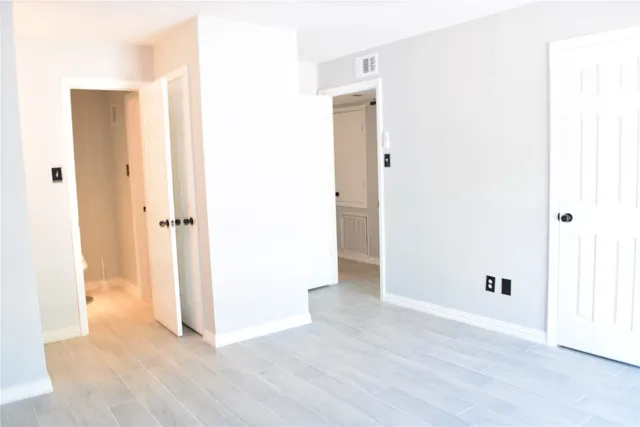 a view of a hallway with wooden floor
