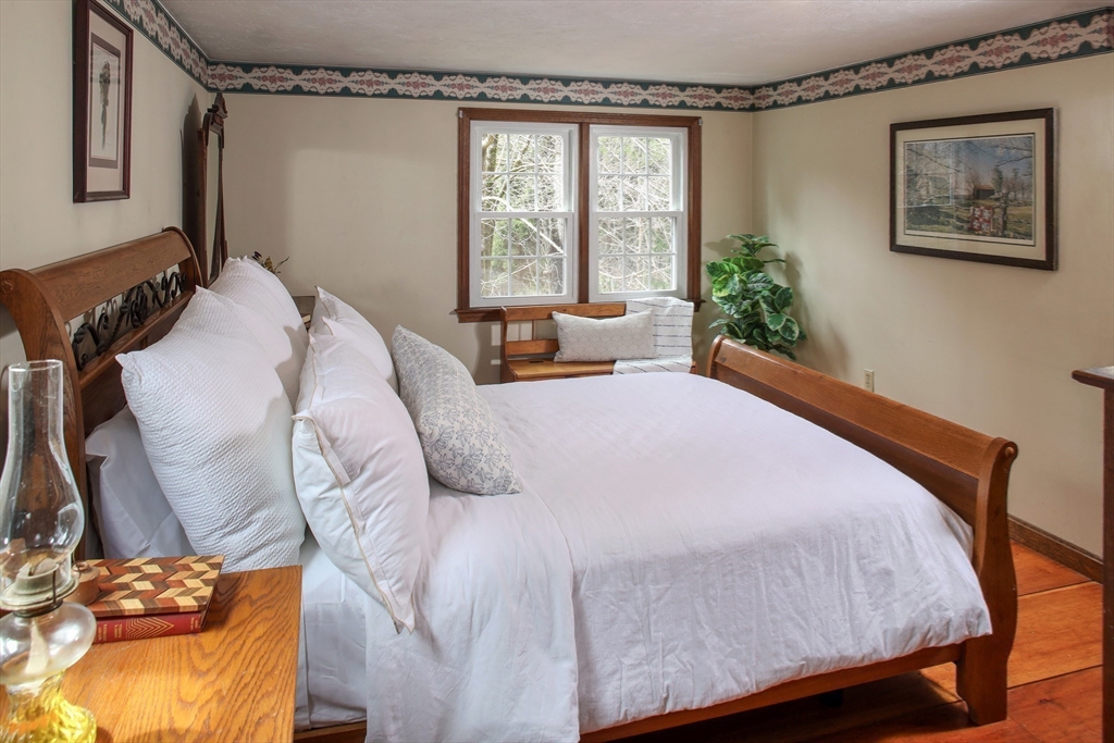 66 Main Street Plympton, MA 02367 - Photo 15 of 31 a bed sitting in a bedroom next to a window