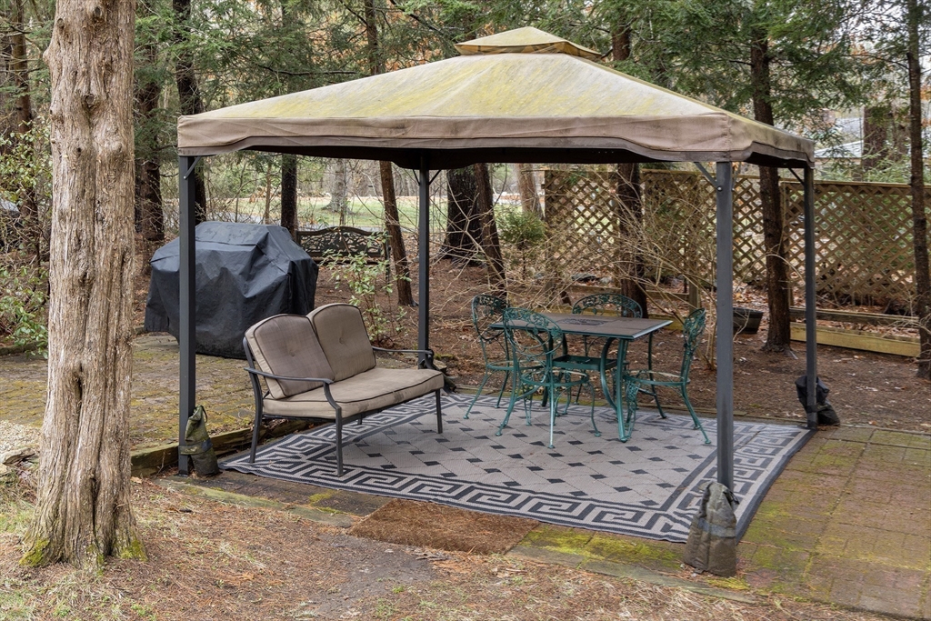 66 Main Street Plympton, MA 02367 - Photo 23 of 31 a view of a patio with a table chairs and a yard