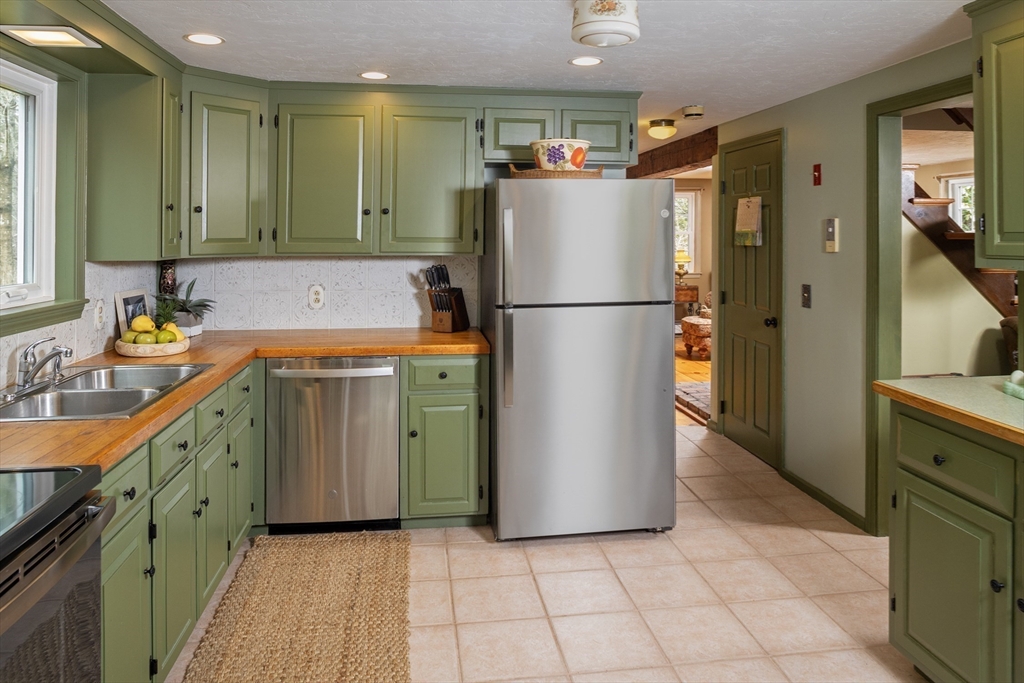 66 Main Street Plympton, MA 02367 - Photo 10 of 31 a kitchen with a refrigerator a sink and dishwasher