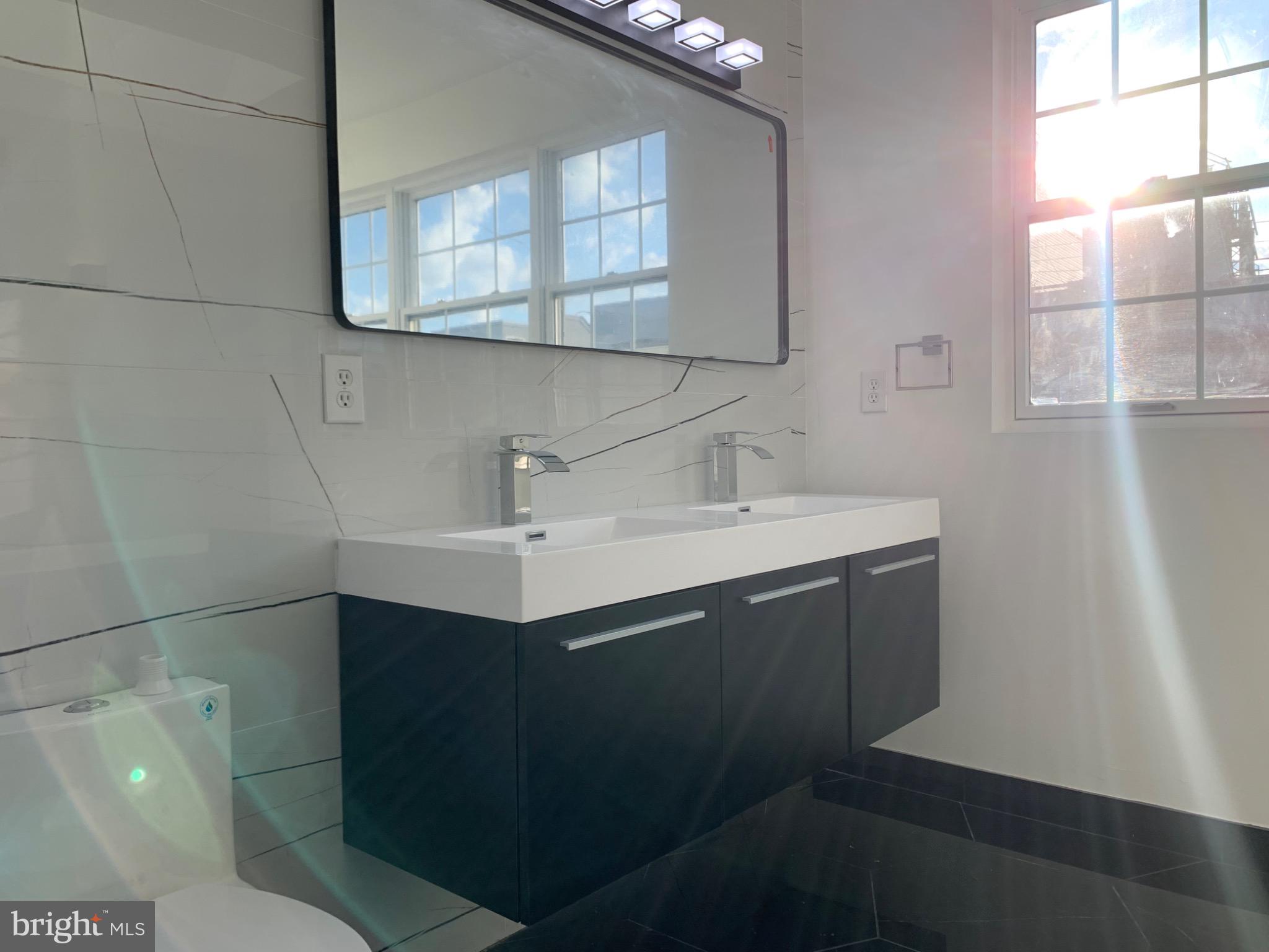 417 North Front Street Philadelphia, PA 19123 - Photo 4 of 11 a bathroom with a sink toilet and mirror