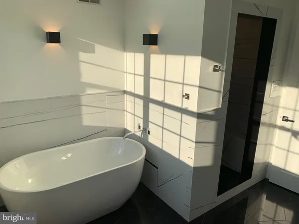 a bathroom with bathtub and window