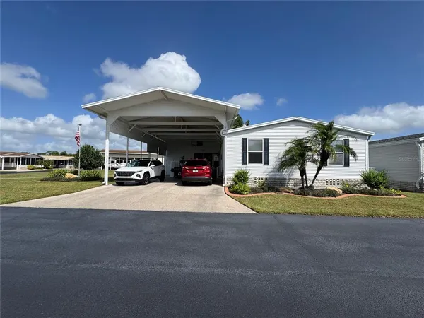 a view of a house with a yard and garage