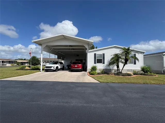 a view of a house with a yard and garage