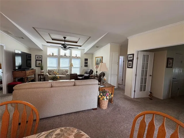 a living room with furniture a window and a flat screen tv