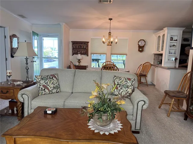 a living room with furniture wooden floor and a chandelier