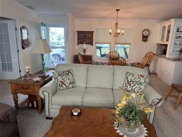 a living room with furniture and a chandelier