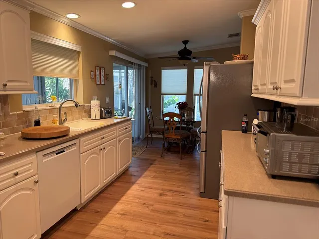 a kitchen with sink a counter space and appliances