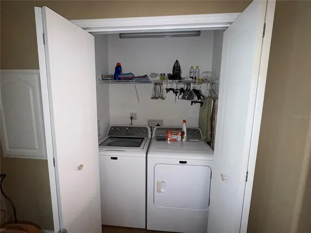a kitchen with white cabinets and black appliances