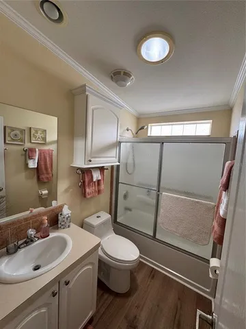 a spacious bedroom with a bed and a chandelier