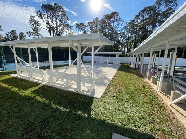 a view of swimming pool with outdoor seating and lake view