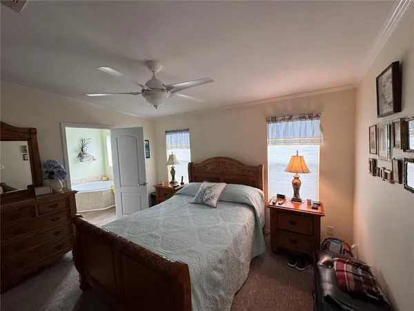 a bedroom with a bed and a tv on the dresser