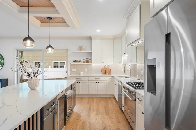 a kitchen with stainless steel appliances granite countertop a sink a stove and a refrigerator