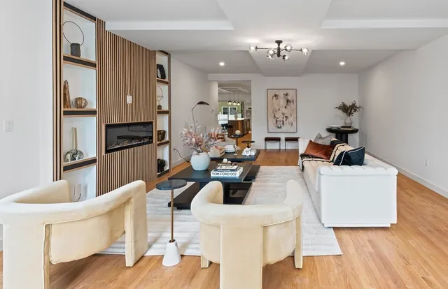 a living room with fireplace furniture and a chandelier