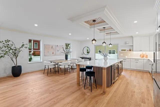 a large kitchen with lots of furniture a sink appliances and a dining table