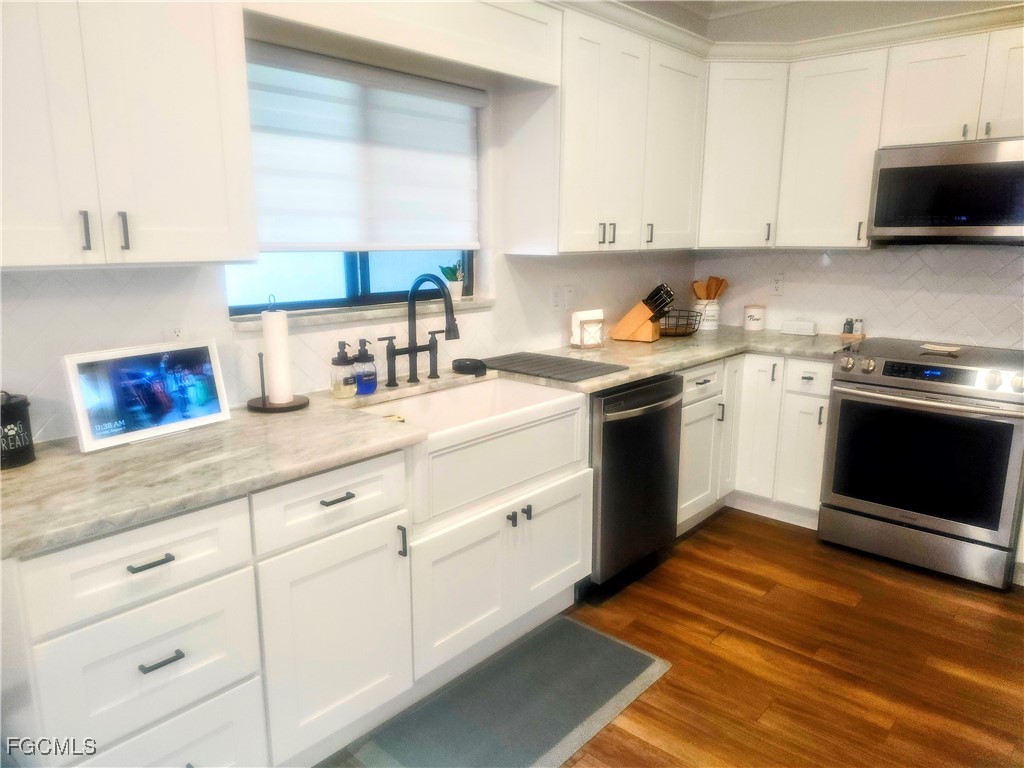 17833 Southwest 155th Court Miami, FL 33187 - Photo 6 of 22 a kitchen with stainless steel appliances granite countertop a stove sink and cabinets