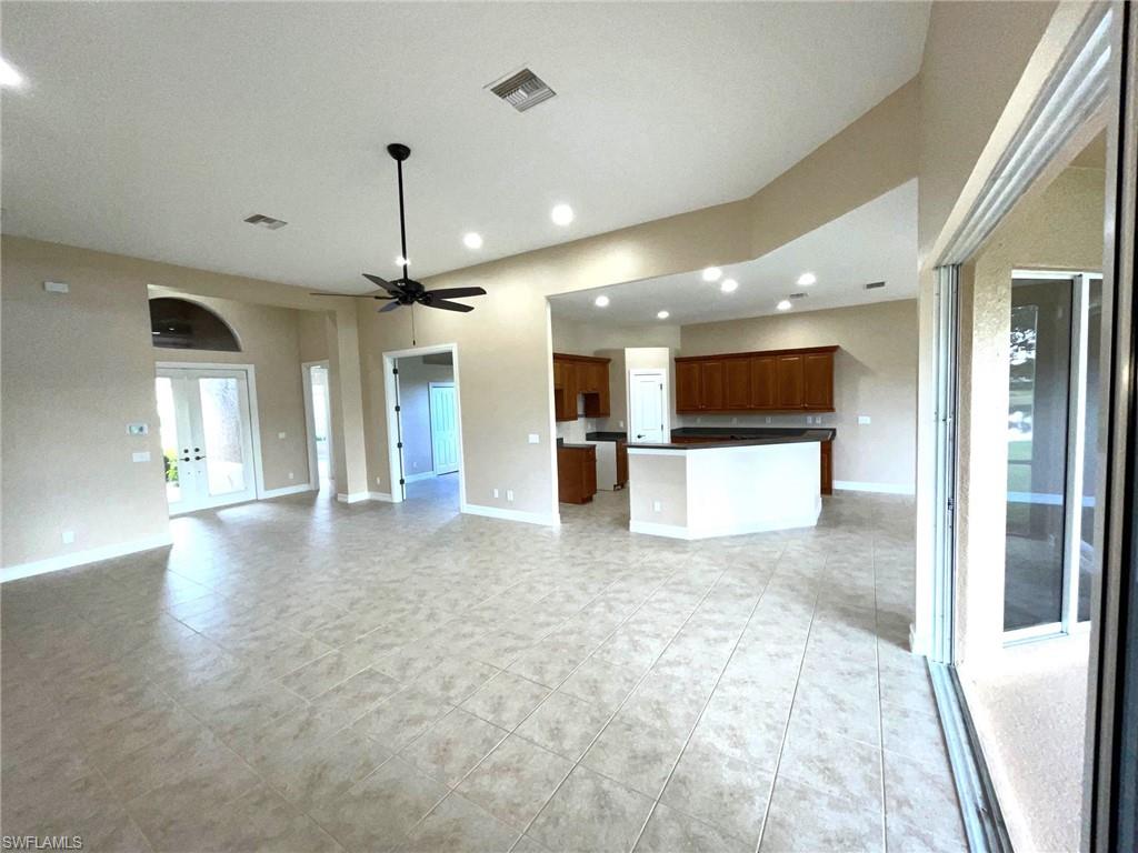 6082 Divot Court Naples, FL 34113 - Photo 14 of 39 a view of a big room with a kitchen