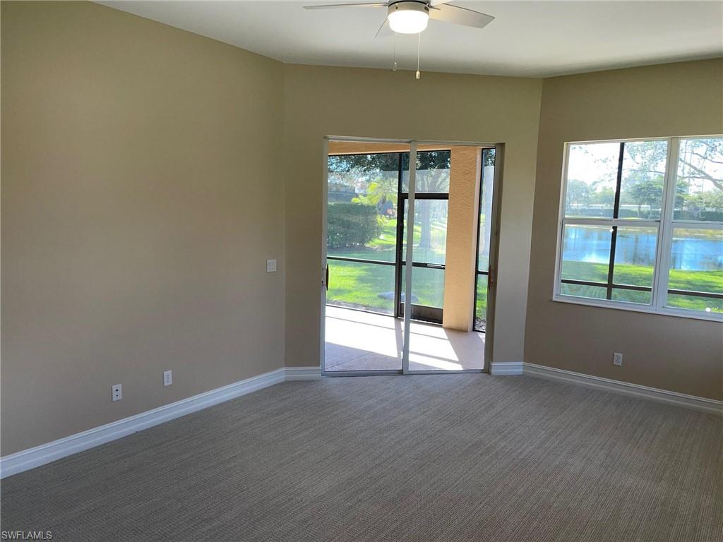 6082 Divot Court Naples, FL 34113 - Photo 22 of 39 an empty room with wooden floor and windows