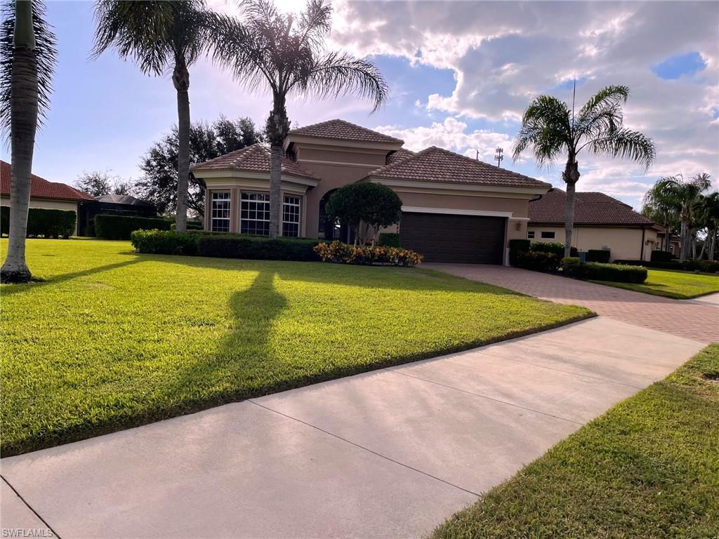 6082 Divot Court Naples, FL 34113 - Photo 3 of 39 a front view of a house with swimming pool having outdoor seating