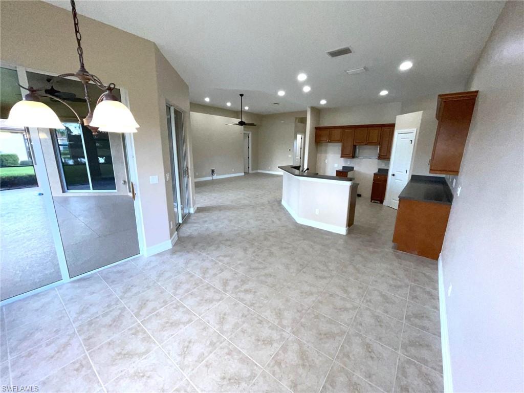 6082 Divot Court Naples, FL 34113 - Photo 10 of 39 a view of kitchen with furniture and wooden floor