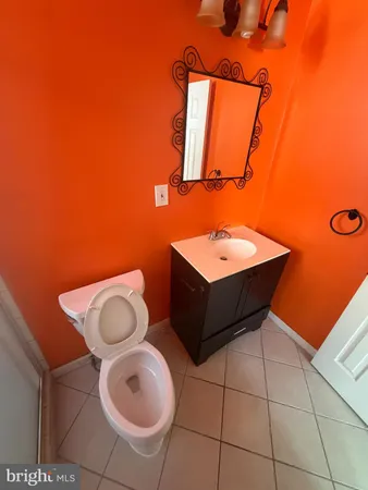 a bathroom with a toilet a sink and mirror