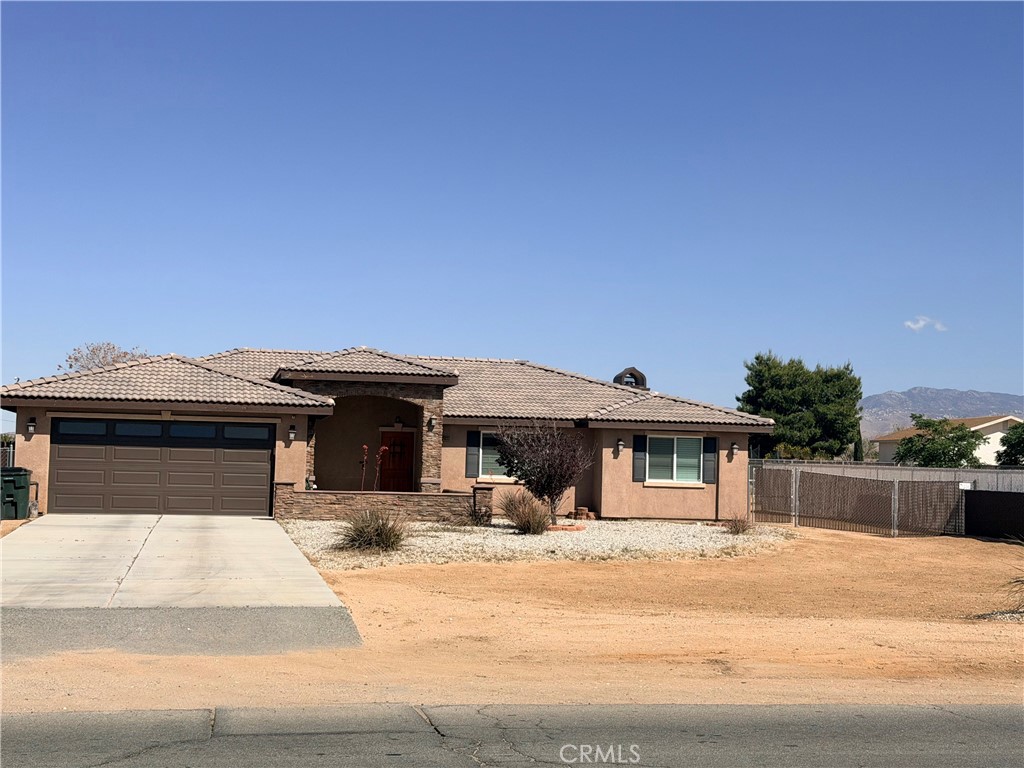 12833 Algonquin Road Apple Valley, CA 92308 - Photo 1 of 16 a front view of a house with a slide