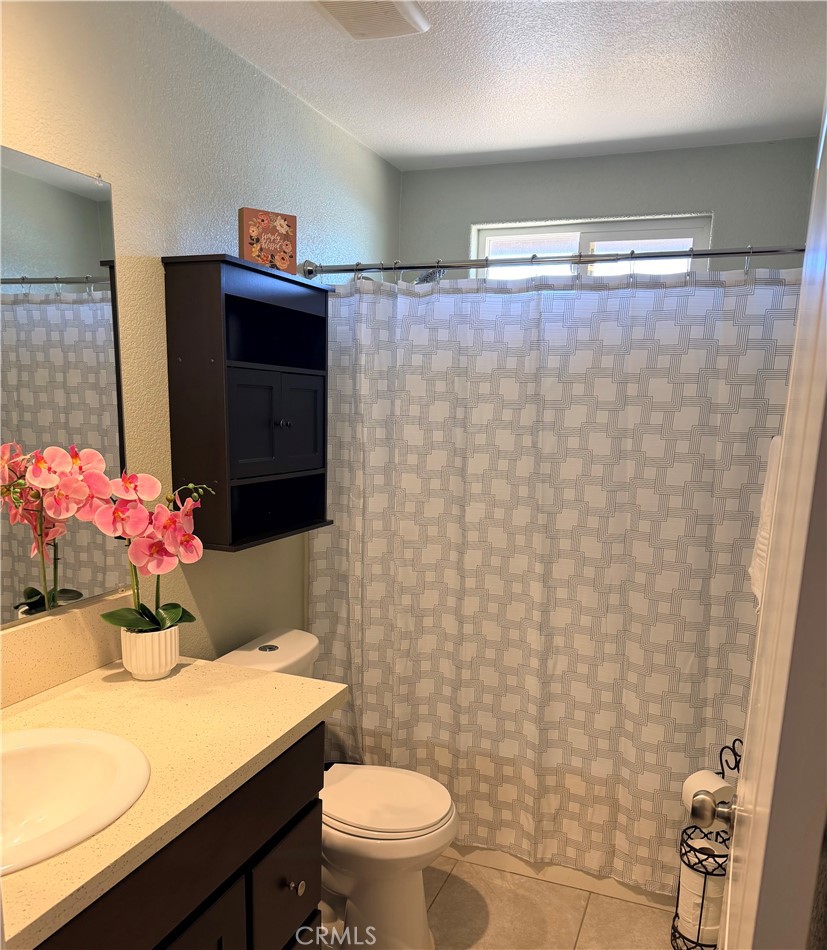 12833 Algonquin Road Apple Valley, CA 92308 - Photo 12 of 16 a bathroom with a sink toilet and shower
