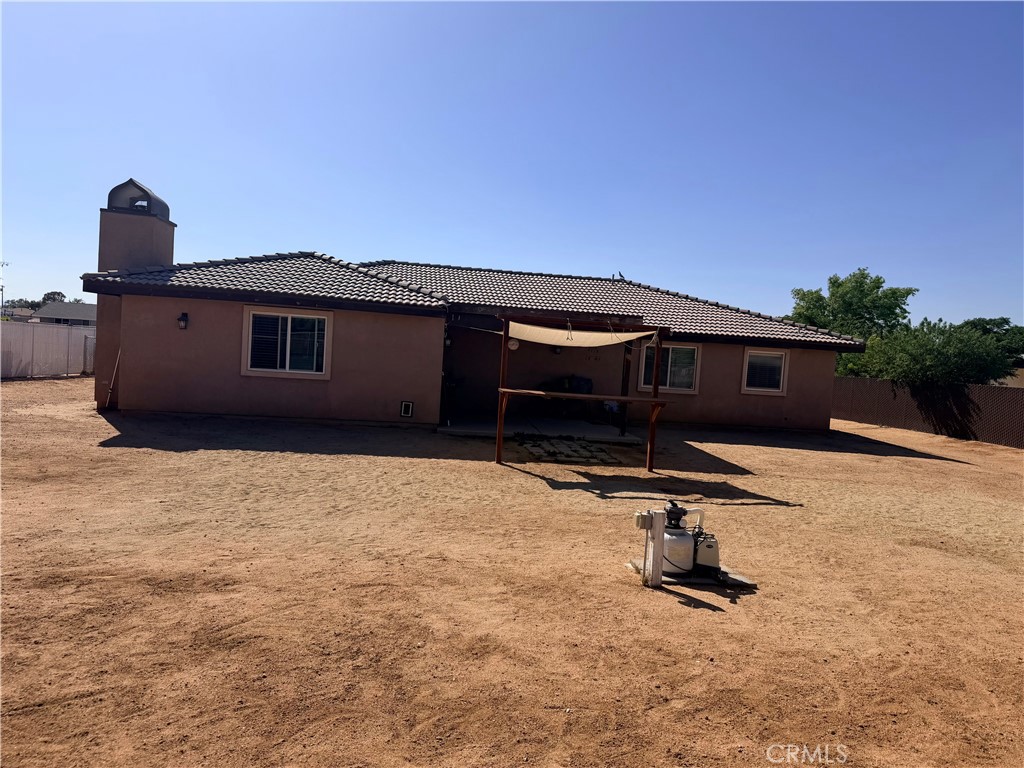 12833 Algonquin Road Apple Valley, CA 92308 - Photo 2 of 16 a view of a house with a yard