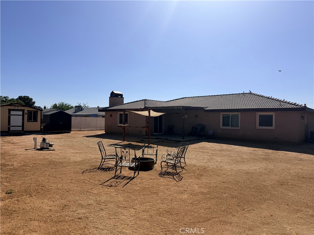12833 Algonquin Road Apple Valley, CA 92308 - Photo 3 of 16 a backyard of a house with table and chairs