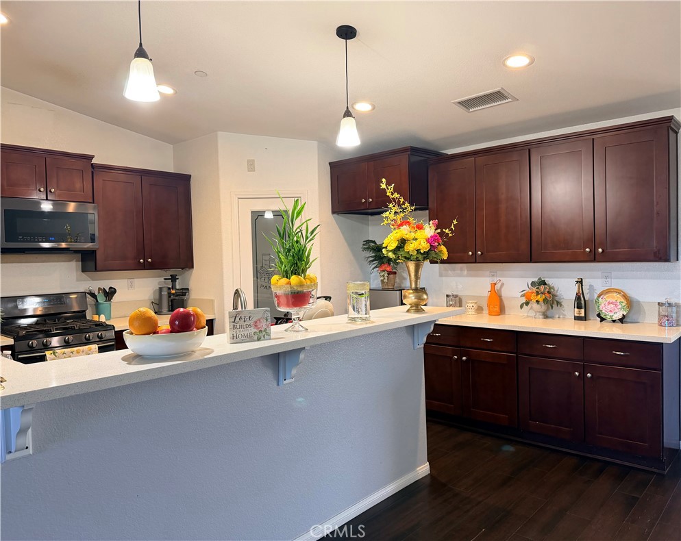 12833 Algonquin Road Apple Valley, CA 92308 - Photo 4 of 16 a kitchen with stainless steel appliances granite countertop a sink refrigerator and cabinets