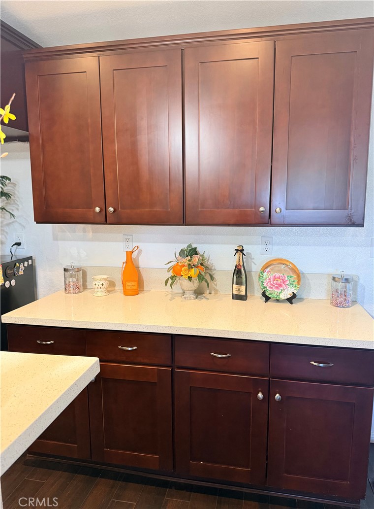12833 Algonquin Road Apple Valley, CA 92308 - Photo 5 of 16 a view of granite countertop cabinets and a wooden floor