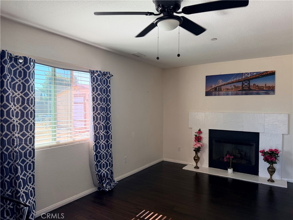 12833 Algonquin Road Apple Valley, CA 92308 - Photo 6 of 16 a living room with furniture and a fireplace