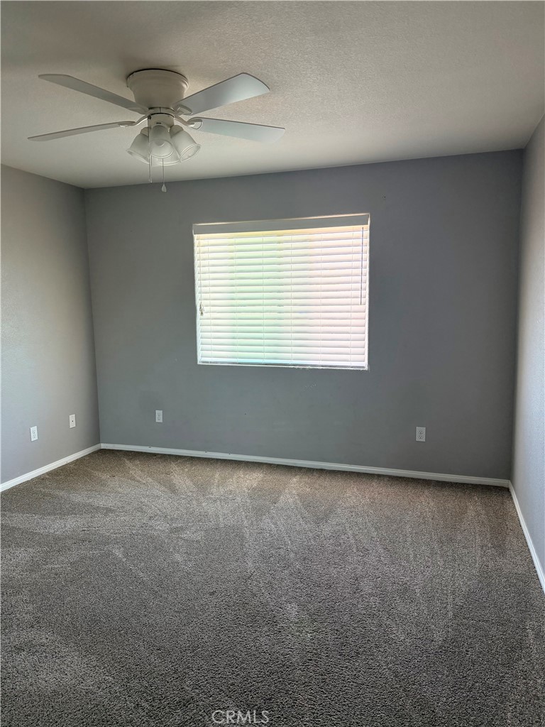 12833 Algonquin Road Apple Valley, CA 92308 - Photo 7 of 16 an empty room with a window