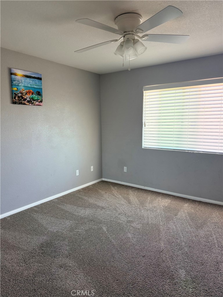 12833 Algonquin Road Apple Valley, CA 92308 - Photo 8 of 16 a view of an empty room with a window
