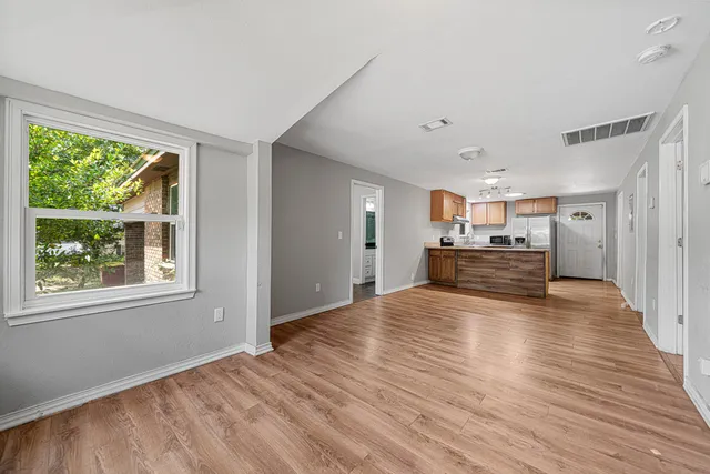 a view of a kitchen with wooden floor and a kitchen