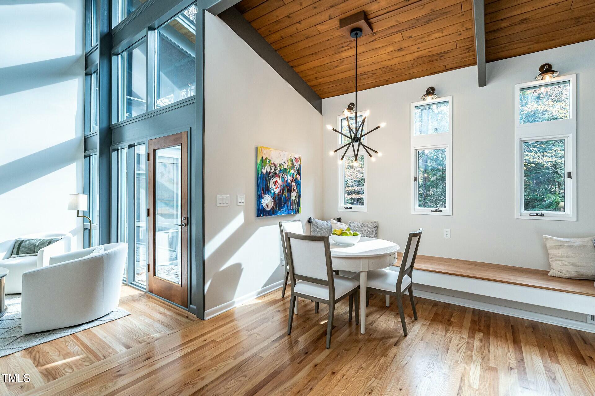 4824 Sandberry Lane Raleigh, NC 27613 - Photo 11 of 38 a view of a dining room with furniture window and wooden floor