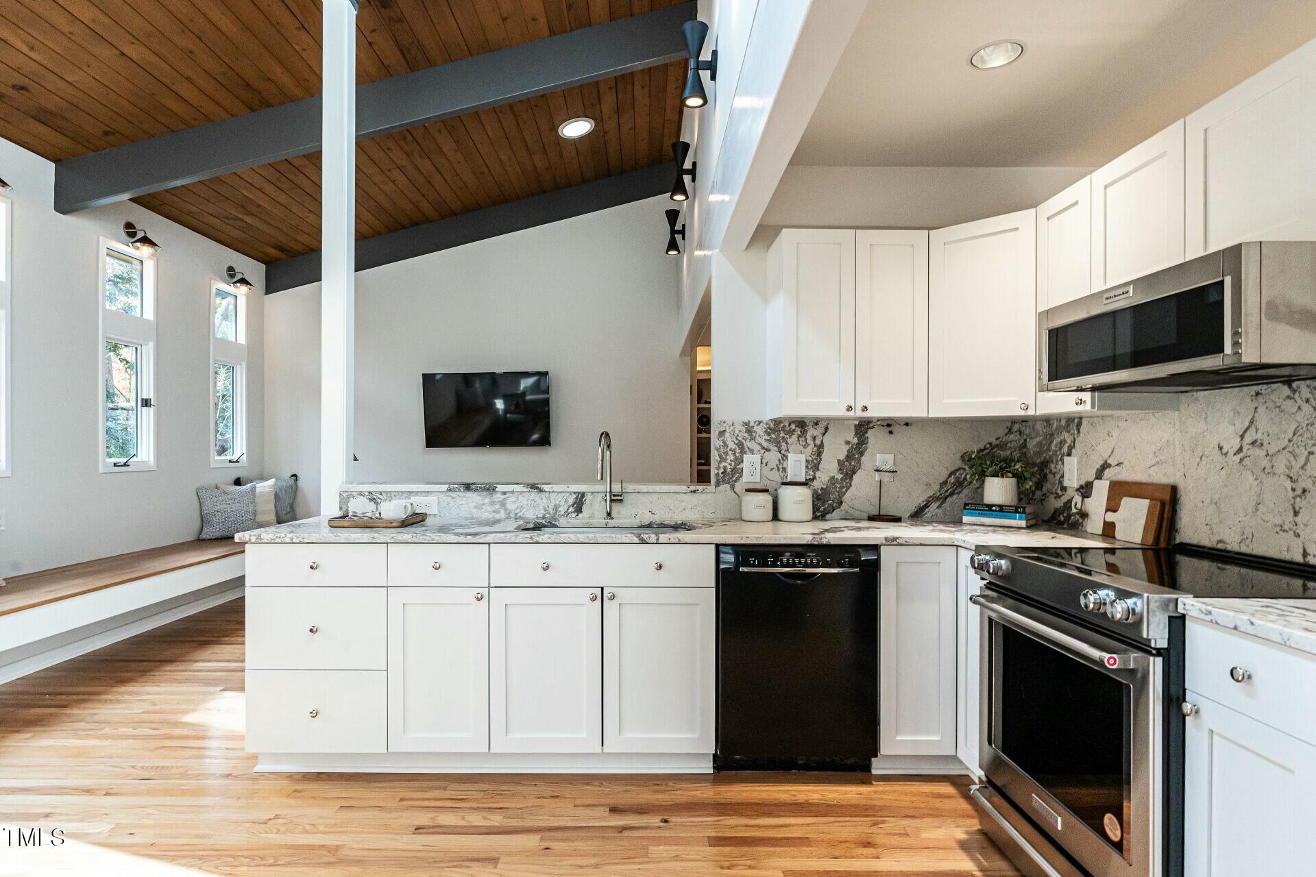 4824 Sandberry Lane Raleigh, NC 27613 - Photo 15 of 38 a kitchen with a sink stove and microwave