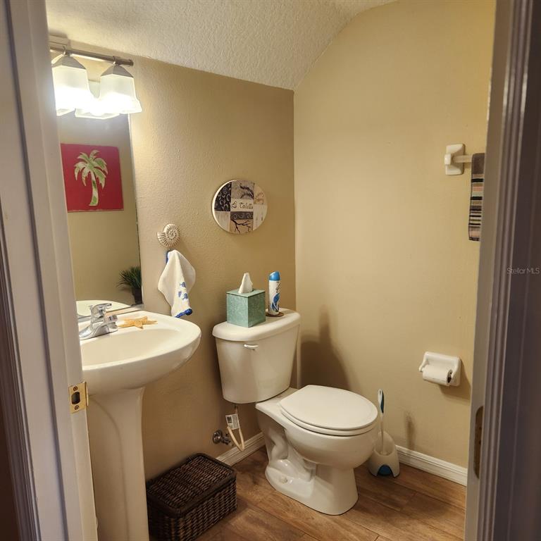 14982 Skip Jack Loop Lakewood Ranch, FL 34202 - Photo 11 of 28 a white toilet sitting next to a bathroom sink
