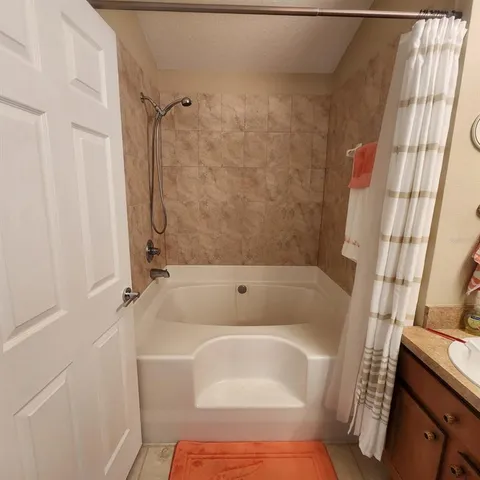 a bathroom with a tub and shower