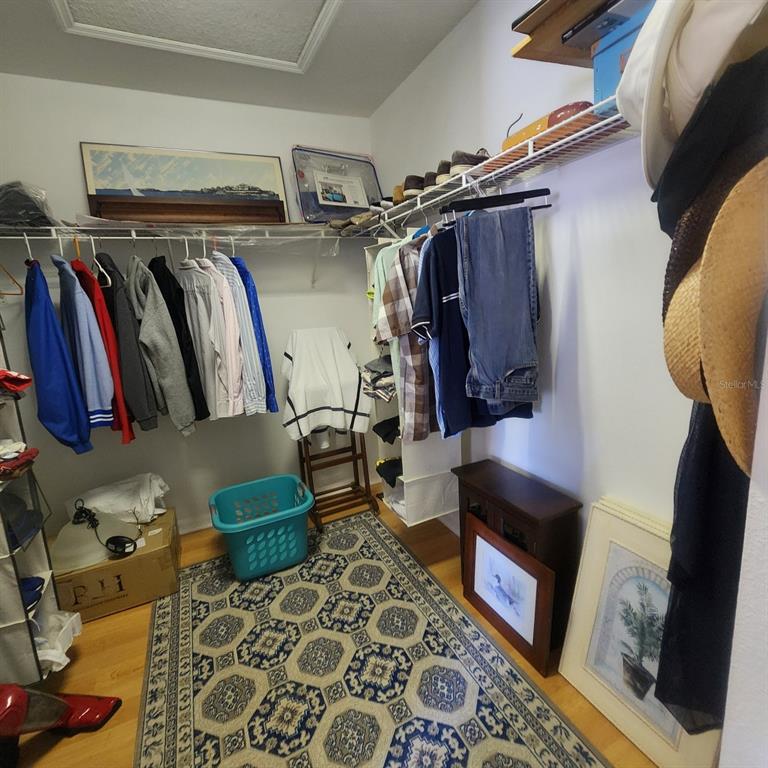 14982 Skip Jack Loop Lakewood Ranch, FL 34202 - Photo 16 of 28 a view of walk in closet with clothes and shoes