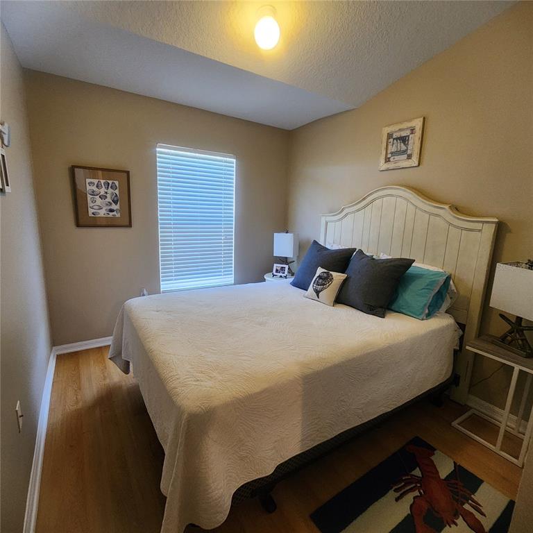 14982 Skip Jack Loop Lakewood Ranch, FL 34202 - Photo 20 of 28 a bedroom with a bed and a night stand