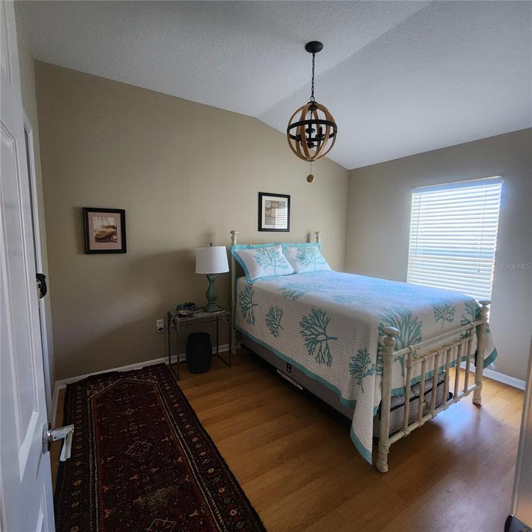 14982 Skip Jack Loop Lakewood Ranch, FL 34202 - Photo 21 of 28 a bedroom with a bed and dresser
