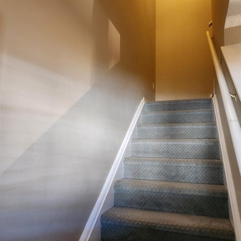 14982 Skip Jack Loop Lakewood Ranch, FL 34202 - Photo 25 of 28 a view of staircase with white walls and white door