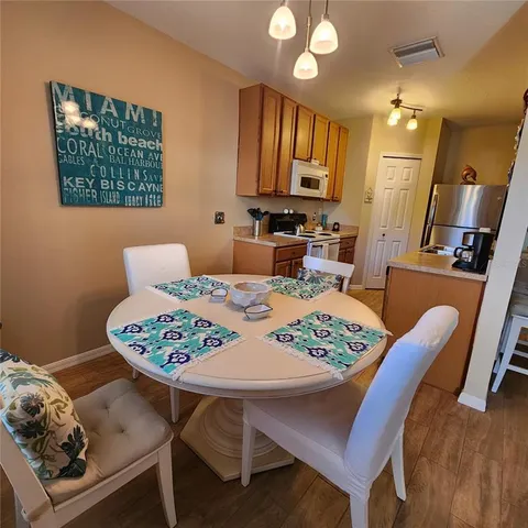 a view of a dining room with furniture and wooden floor