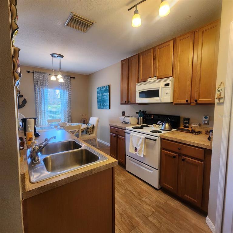14982 Skip Jack Loop Lakewood Ranch, FL 34202 - Photo 7 of 28 a kitchen that has a sink and cabinets