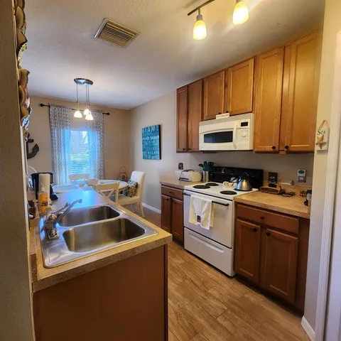 a kitchen that has a sink and cabinets