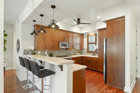 a kitchen with a sink a stove and cabinets