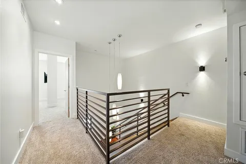 a bedroom with a bed a couch and a potted plant